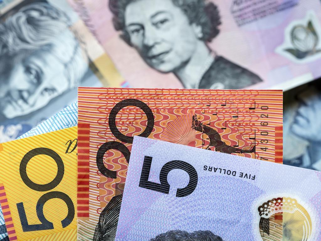 Australian money background. Focus on foreground, blurred faces beneath. Notes generic