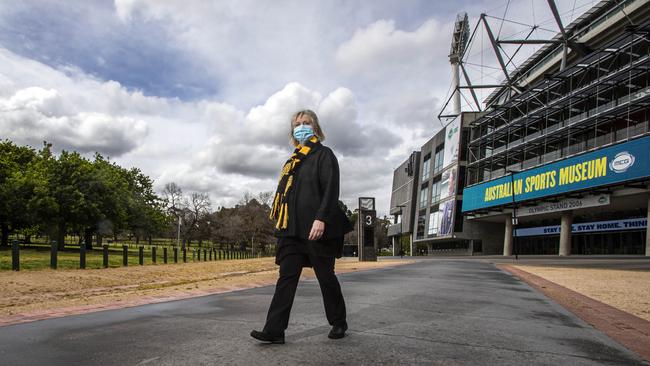 Richmond president Peggy O’Neal walks past the Melbourne Cricket Ground, which should have been the pulsating focus of the AFL grand final this weekend. Picture: Aaron Francis