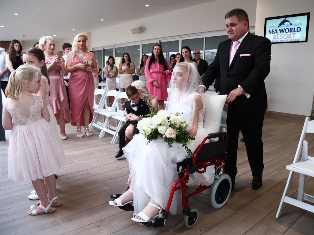 Ashleigh’s father Tony pushing her down the isle. Picture: Jason O’Brien