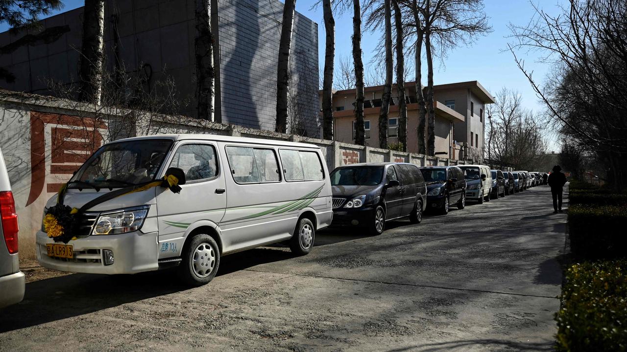 Hearses are seen waiting to enter a crematorium in Beijing on December 22. Picture: AFP.