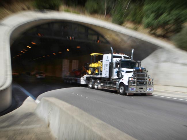 Truck coming out of the Heysen Tunnel on the down track of the freeway. New laws governing the speed of heavy vehicles with 5 axles or more coming down the South Eastern Freeway to Adelaide.