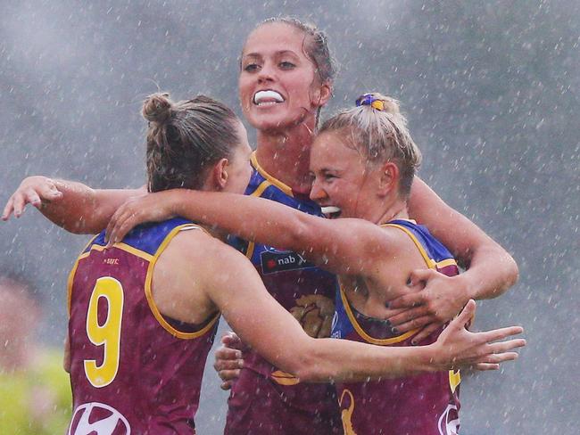 Kate McCarthy, Kaitlyn Ashmore and Megan Hunt celebrate Brisbane’s upset win. Picture: Getty Images