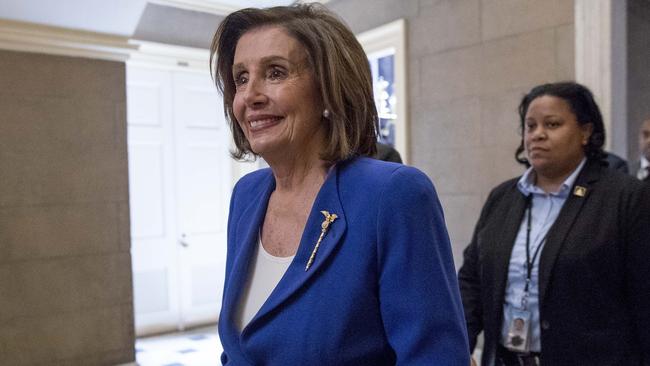 Nancy Pelosi walks to her office after signing the Coronavirus Aid, Relief, and Economic Security (CARES) Act. Picture: AP.