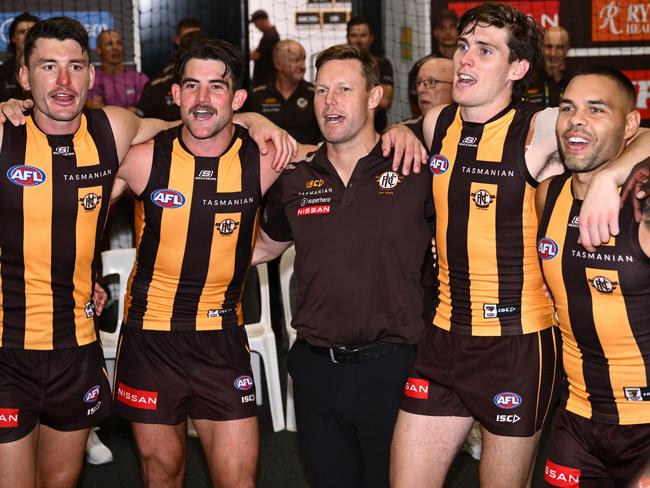 MELBOURNE, AUSTRALIA - MARCH 14: Josh Battle, Jai Newcombe, Sam Mitchell, Will Day and Jarman Impey of the Hawks  sing the song in the rooms after winning the round one AFL match between Hawthorn Hawks and Essendon Bombers at Melbourne Cricket Ground, on March 14, 2025, in Melbourne, Australia. (Photo by Quinn Rooney/Getty Images)