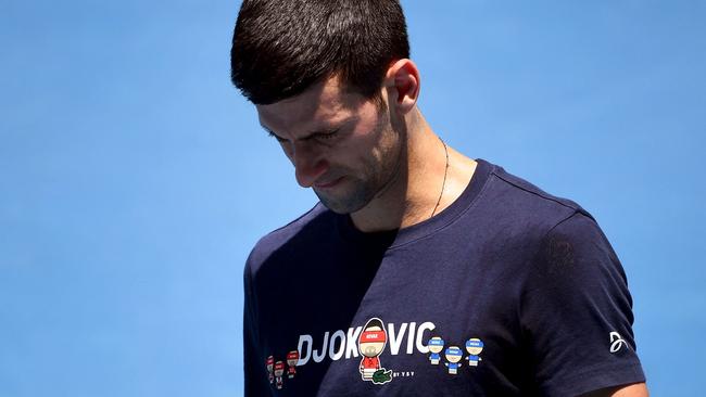 Novak Djokovic of Serbia looks at his racquet during a practice session before he was deported on Sunday.Picture: William West/AFP