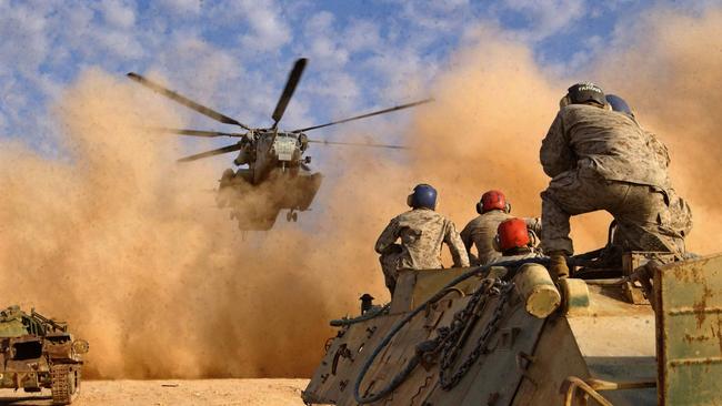 US Marines watching for the approach of a CH-53E Super Stallion in March 2003