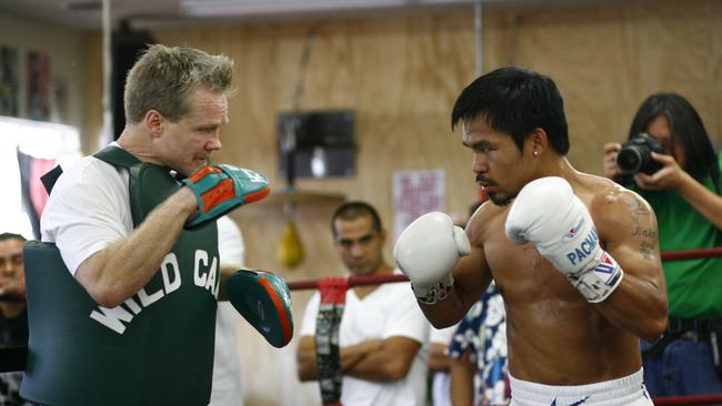 Trainer Freddie Roach works with charge Manny Pacquiao. Courtesy: Top Rank.