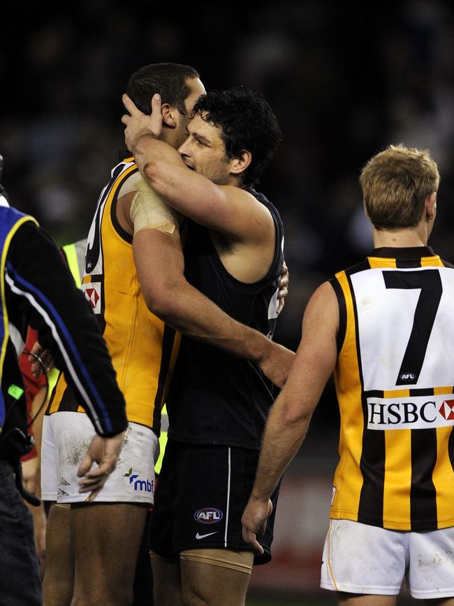 Lance Franklin, who reached 100 goals on the night, gets a hug from Brendan Fevola.