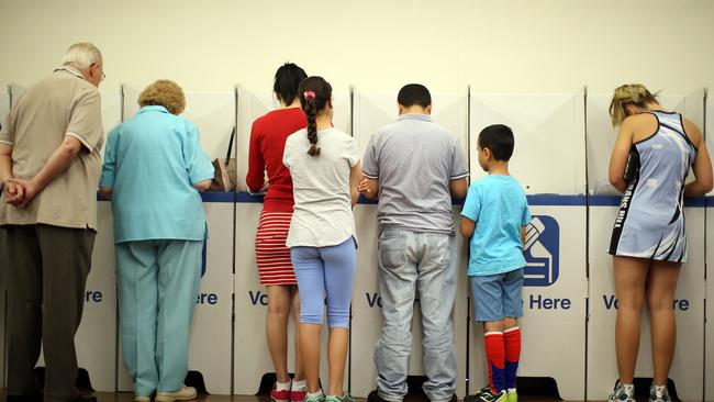 People voting in the state election at Currins Hill Public School. Picture: Jonathan Ng