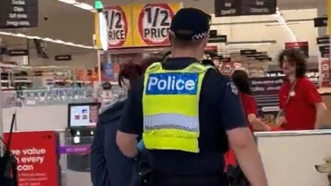 Police officers arrest a women in Bay Street, Port Melbourne  for stealing on Tuesday. Source: Supplied,