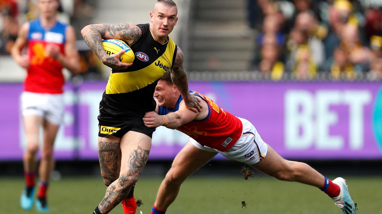 Dustin Martin of the Tigers fends off Alex Witherden of the Lions at the MCG on August 25. Dustin Martin is one of only a few AFL players who earn more than $1 million a year. Picture: Getty Images