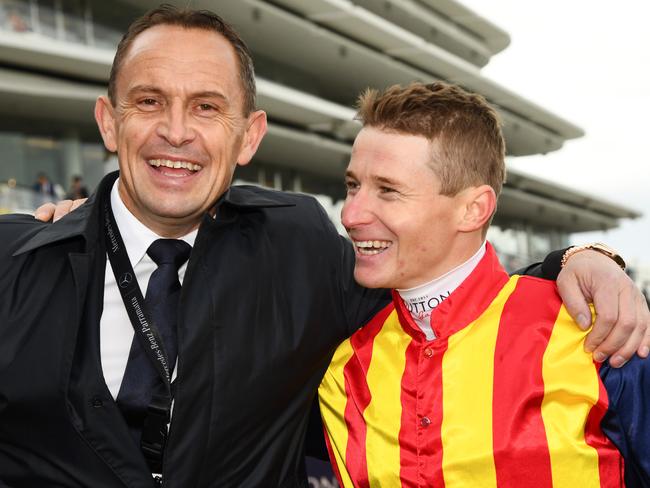 Trainer Chris Waller poses with jockey James McDonald after he rode Nature Strip to victory in race 5, the Darley Sprint Classic, during Seppelt Wines Stakes Day at Flemington Racecourse in Melbourne, Saturday, November 9, 2019. (AAP Image/Vince Caligiuri) NO ARCHIVING, EDITORIAL USE ONLY