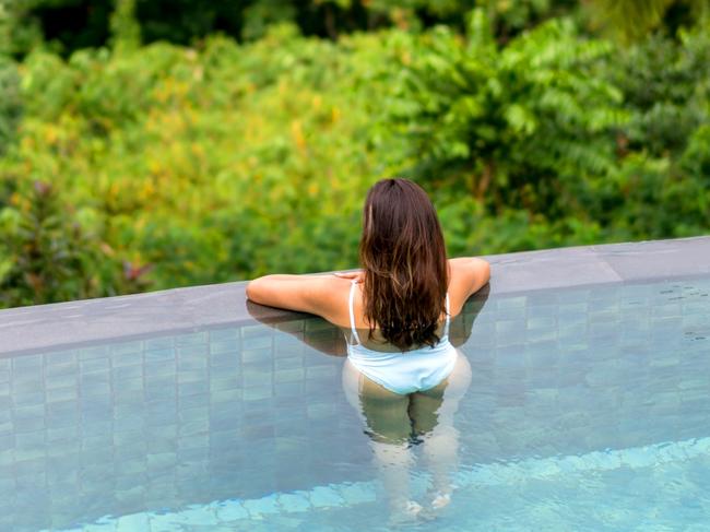 ESCAPE:  Beautiful woman relaxing on her vacations in the swimming pool and looking at the view  Picture: Istock