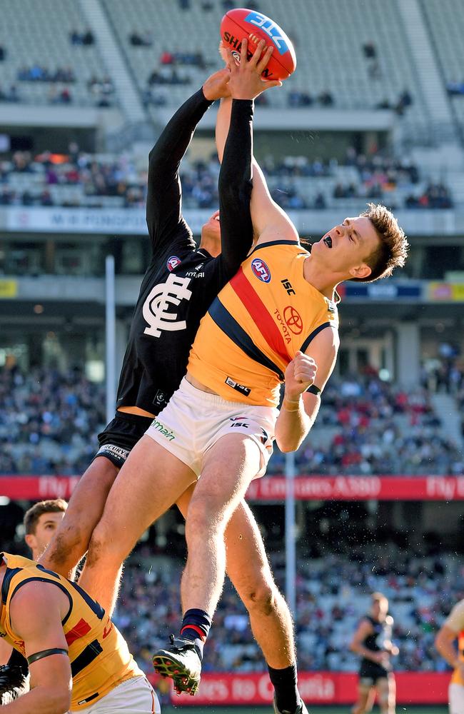 Jake Lever flies to spoil Carlton’s Jack Silvagni.