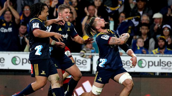 Elliot Dixon of the Highlanders celebrates his try at Forsyth Barr Stadium.