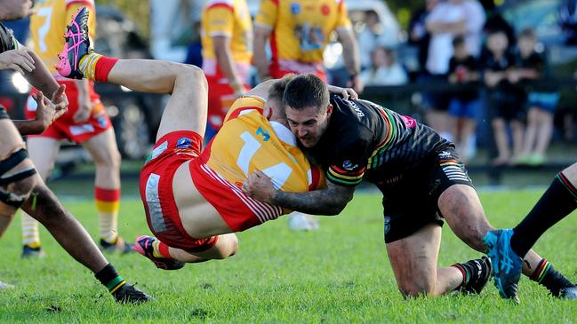 Coffs Harbour's Patrick Carey hit in a heavy tackle. Picture: Leigh Jensen