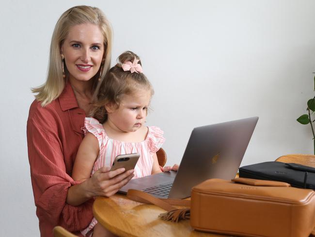 SYDNEY, AUSTRALIA - MARCH 04 2022: Melody Ziri is seen working from home with her with her daughter Brooklyn Ziri. Melody is an example of someone with 'rest resistance' a term based on research that shows many people gain accomplishment from being busy. Despite her demanding corporate job and toddler,  Melody started a side-hustle designing and selling compact pram-compatible baby bags in Sydney. Picture: Newscorp Daily Telegraph / Gaye Gerard