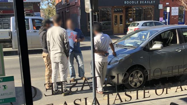 Uber Eats drivers parked on Elizabeth St, outside Taste of Asia, waiting for an order to come through.