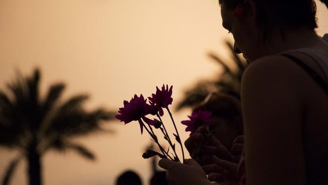 Kathleen Kerr, of Orlando, Florida, lays flowers at a makeshift memorial for the victims of the Pulse nightclub massacre. Picture: AP Photo/David Goldman