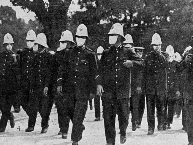 Police in masks on the streets of Sydney in 1919. The virus severely depleted force numbers.