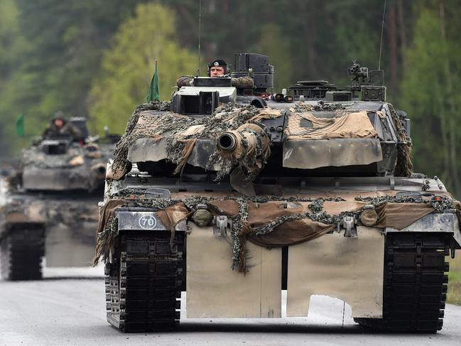 (FILES) This file photo taken on May 12, 2017 shows German soldiers on Lepard tanks arriving for a friendship shooting of several nations during the exercise 'Strong Europe Tank Challenge 2017' at the military training area in Grafenwoehr, near Eschenbach, southern Germany. - Germany on January 25, 2023 approved the delivery of Leopard 2 tanks to Ukraine, after weeks of pressure from Kyiv and many allies. Berlin will provide a company of 14 Leopard 2 A6 tanks from the Bundeswehr stocks and is also granting approval for other European countries to send tanks from their own stocks to Ukraine, a government spokesman said in a statement. (Photo by Christof STACHE / AFP)