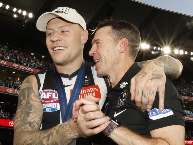 MELBOURNE, AUSTRALIA - SEPTEMBER 30: Jordan De Goey of the Magpies and Craig McRae, Senior Coach of the Magpies embrace after the 2023 AFL Grand Final match between Collingwood Magpies and Brisbane Lions at Melbourne Cricket Ground, on September 30, 2023, in Melbourne, Australia. (Photo by Darrian Traynor/AFL Photos/via Getty Images)