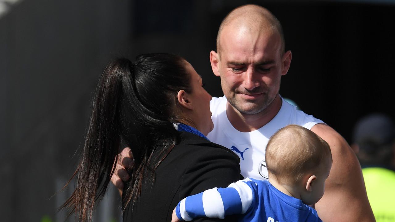 An emotional Ben Cunnington hugs his wife Belinda and kids before his AFL return game last week against Adelaide after beating cancer. Picture: Getty Images