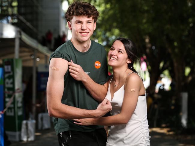 Dashiel Farraway, 18 of Wynnum alongside partner Taylor Schroder, 18 of Holland Park as they both received their first dose of the Pfizer vaccine at the Brisbane Convention and Exhibition Centre. Picture: Zak Simmonds