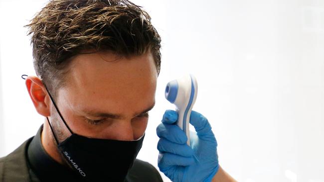 MELBOURNE, AUSTRALIA - OCTOBER 18: Jack Gunston of the Hawks has his temperature checked before the 2020 Brownlow Medal Count at NEP Studios Southbank on October 18, 2020 in Melbourne, Australia.  (Photo by Darrian Traynor/Getty Images)