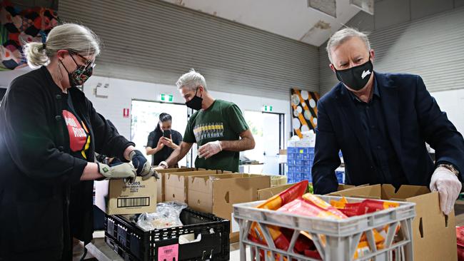 Sam Mostyn, Craig Foster and then Opposition leader Anthony Albanese help pack food packages at Addison Road Community Organisation in Marrickville in 2021. Picture: NCA NewsWire / Adam Yip