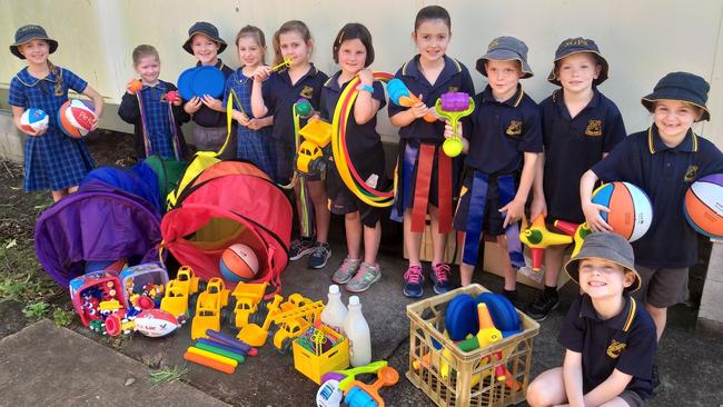 Infants students with the Sporting Equipment which was purchased with money from recycling.