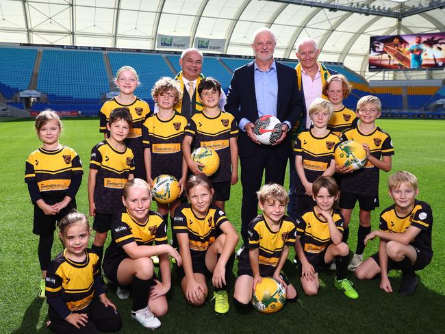 Graham Arnold, Socceroos head coach, Experience Gold Coast CEO John Warn, Mayor Tom Tate and players from Mudgeeraba Soccer Club. Picture: Chris Hyde/Getty Images.