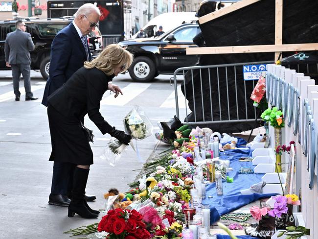 TOPSHOT - US President Joe Biden and First Lady Jill Biden lay flowers as they pay their respects to victims of the January 1 truck attack at a makeshift memorial in Bourbon Street in New Orleans, Louisiana, on Janauary 6, 2025. Biden is also scheduled to meet with the families of victims of the deadly truck-ramming attack that killed 14 people early on January 1. (Photo by ROBERTO SCHMIDT / AFP)