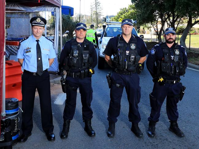 Superintendent Mark Wheeler with his fellow Queensland Police officers re-enact a famous photo from 1919 when the QLD/NSW border was closed due to the Spanish flu Picture Scott Powick.