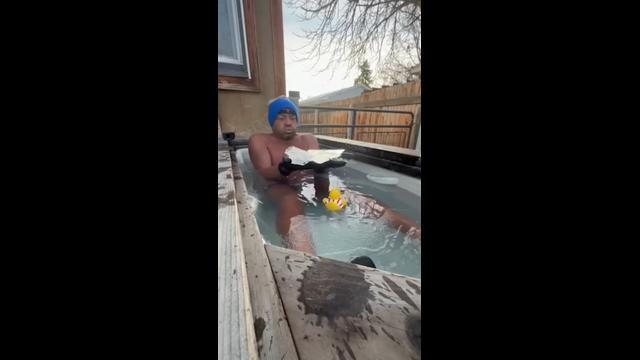 Cold-plunge enthusiast stays put as outdoor tub freezes over