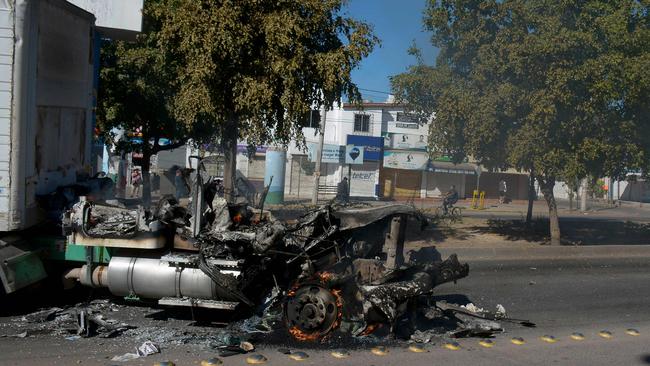 A burnt-out truck in Culiacan marks the arrest of Ovidio Guzman on Thursday. Picture: AFP