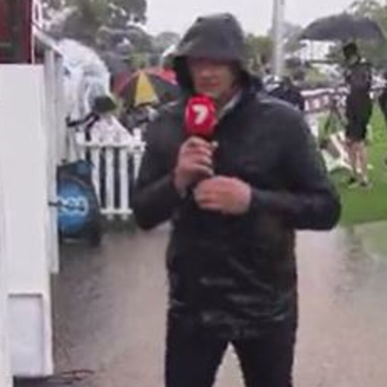 Channel 7’s boundary rider in ankle deep water at the entrance to the player’s race.