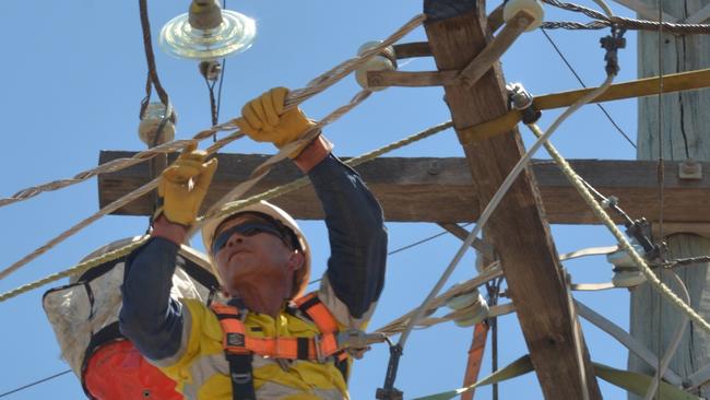 An Ergon Energy worker restoring power to a power line. File Picture: Supplied