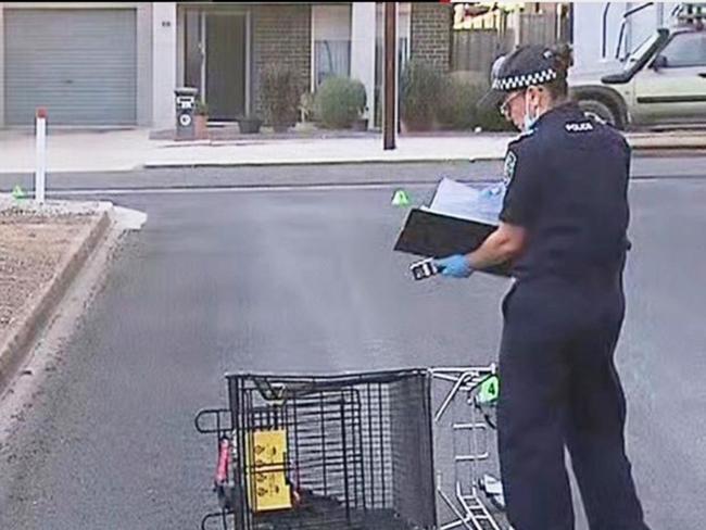 Police examine a shopping trolley as a 34-year-old man is clinging to life after a brutal assault at Murray Bridge. Picture: 7NEWS Adelaide