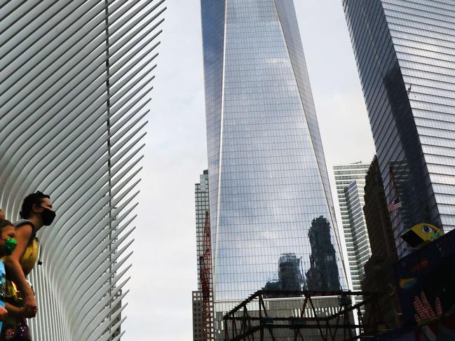 NEW YORK, NEW YORK - SEPTEMBER 11: People walk by One World Trade Center, the Freedom Tower, which stands at Ground Zero in lower Manhattan as people prepare to commemorate the September 11, 2001 terror attacks on September 11, 2020 in New York City. Hundreds of people have gathered for the 19th anniversary of the event at Ground Zero to remember the nearly 3,000 who were killed on that day. But this year, due to COVID-19 pandemic restrictions, only family members are allowed to gather at the 9/11 Memorial plaza. There will also not be an in-person reading of the victimsÃ¢â¬â¢ names at the memorial and instead there will be a pre-recording of names by family members broadcast throughout the plaza and live-streamed online.   Spencer Platt/Getty Images/AFP == FOR NEWSPAPERS, INTERNET, TELCOS & TELEVISION USE ONLY ==