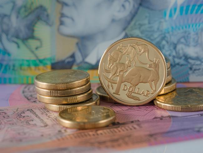 One and Two Dollar Coins Australian ten and five dollar notes in the background - Australian Currency; savings money notes generic