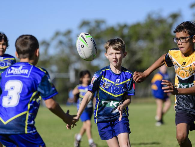 Jaxon Uebergang (centre) of Glenvale State School gets a pass away under pressure from Jahmahal Sedeek of Rockville State School in the inaugural Primary Interschools Reconciliation Touch Carnival hosted by Glenvale State School, Wednesday, May 28, 2025. Picture: Kevin Farmer