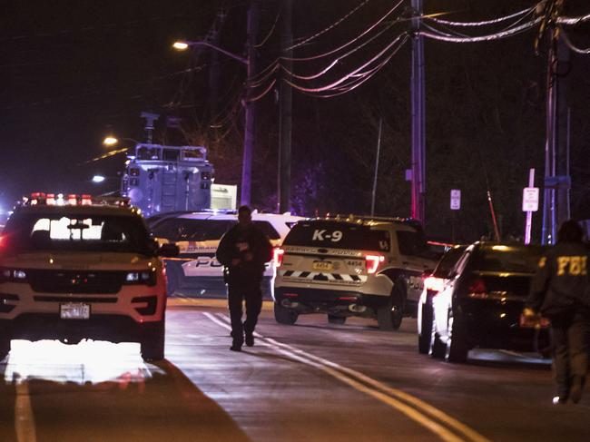 Authorities gather on a street in Monsey, New York, following a stabbing during a Hanukkah celebration. Picture: AP