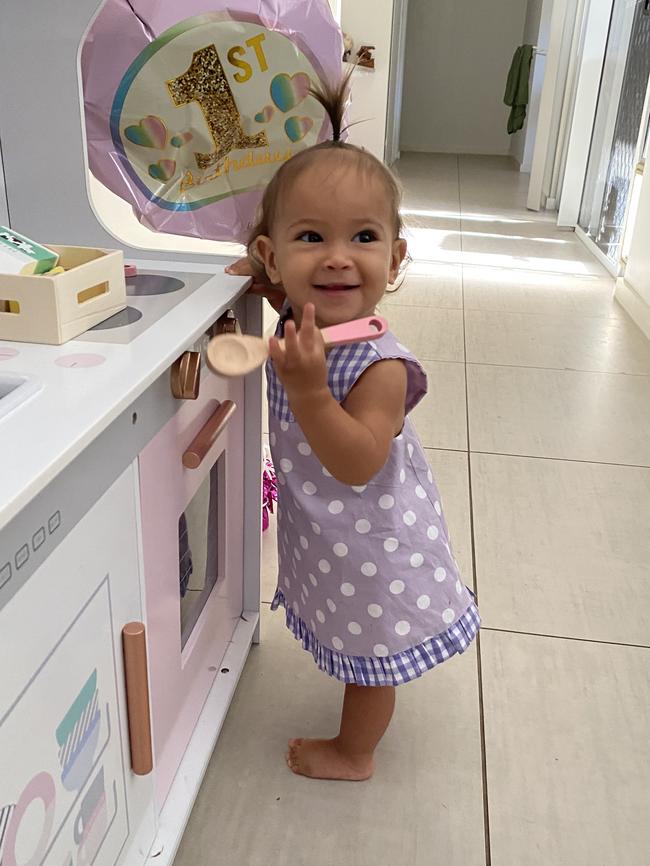 Freya Warner plays in her kitchen