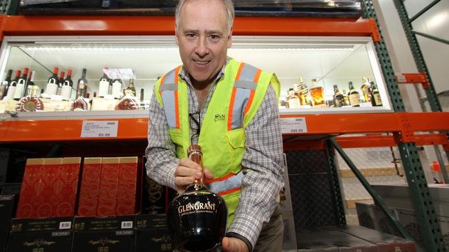 Costco Wholesale Australia’s managing director Patrick Noone with a bottle of single malt Scotch whisky for sale at a whopping $13,999.99.