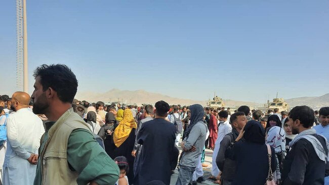 Afghans crowd at the Kabul airport tarmac to try to flee the country. Picture: AFP