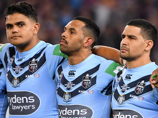 Blues players Latrell Mitchell (left) Josh Addo-Carr (centre) and Cody walker look on during the national anthem during Game 1 of the 2019 State of Origin series between the NSW Blues and the Queensland Maroons at Suncorp Stadium in Brisbane, Wednesday, June 5, 2019. (AAP Image/Dave Hunt) NO ARCHIVING, EDITORIAL USE ONLY