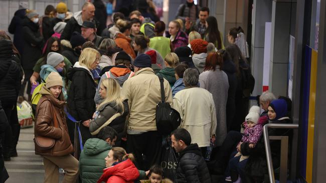 People who have arrived from war-torn Ukraine stand in line at an aid center offering help and information on temporary housing in the main railway station in Krakow, Poland. Picture: Getty