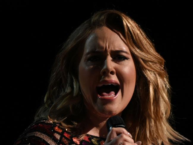 (FILES) This file photo taken on February 12, 2017 shows British singer Adele performing onstage during the 59th Annual Grammy music Awards in Los Angeles. Adele has confirmed years of speculation that she is married. The English singer has been in a long-term relationship with Simon Konecki, a former financier who founded drop4drop, a charity that presses for global access to clean drinking water. She confirmed their status at a concert in Brisbane, Australia on March 5, 2017. / AFP PHOTO / VALERIE MACON