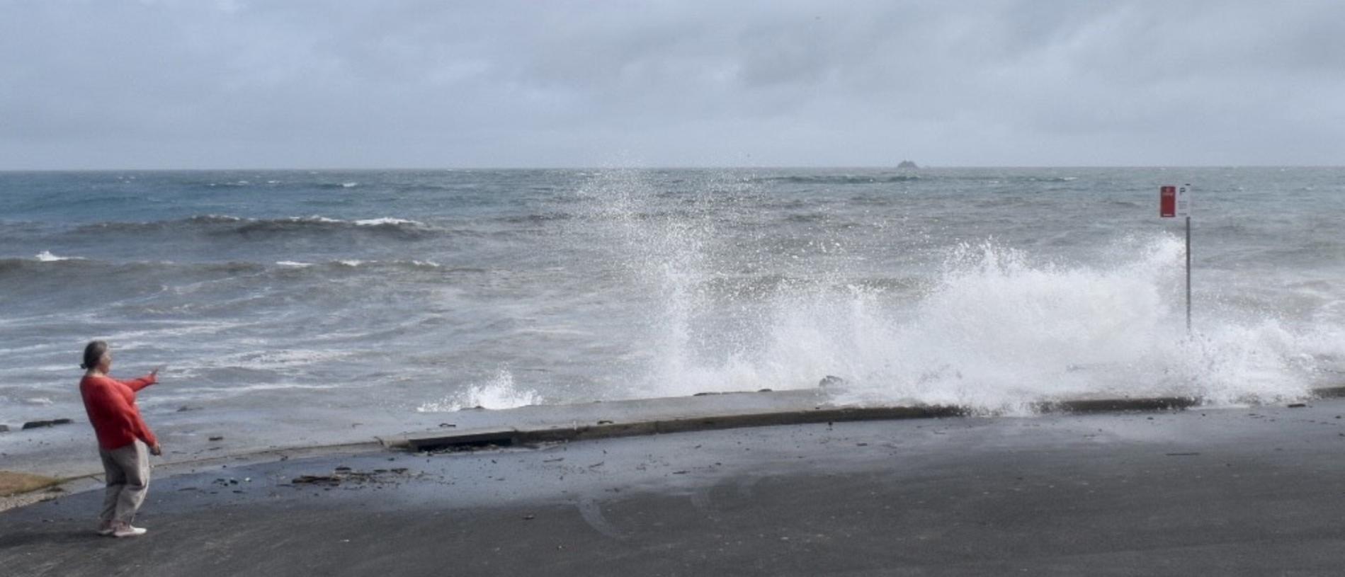 Main Beach in Byron Bay remained closed but many visitors and residents decided to check out the high tide on Tuesday morning.